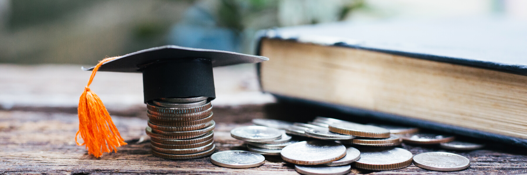 Scholarship concept, cap on top of the money with book