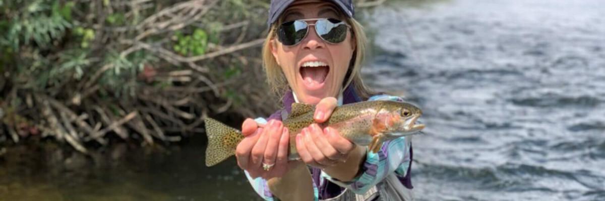 Image of Idaho Governor's Cup event guest holding a fish she caught